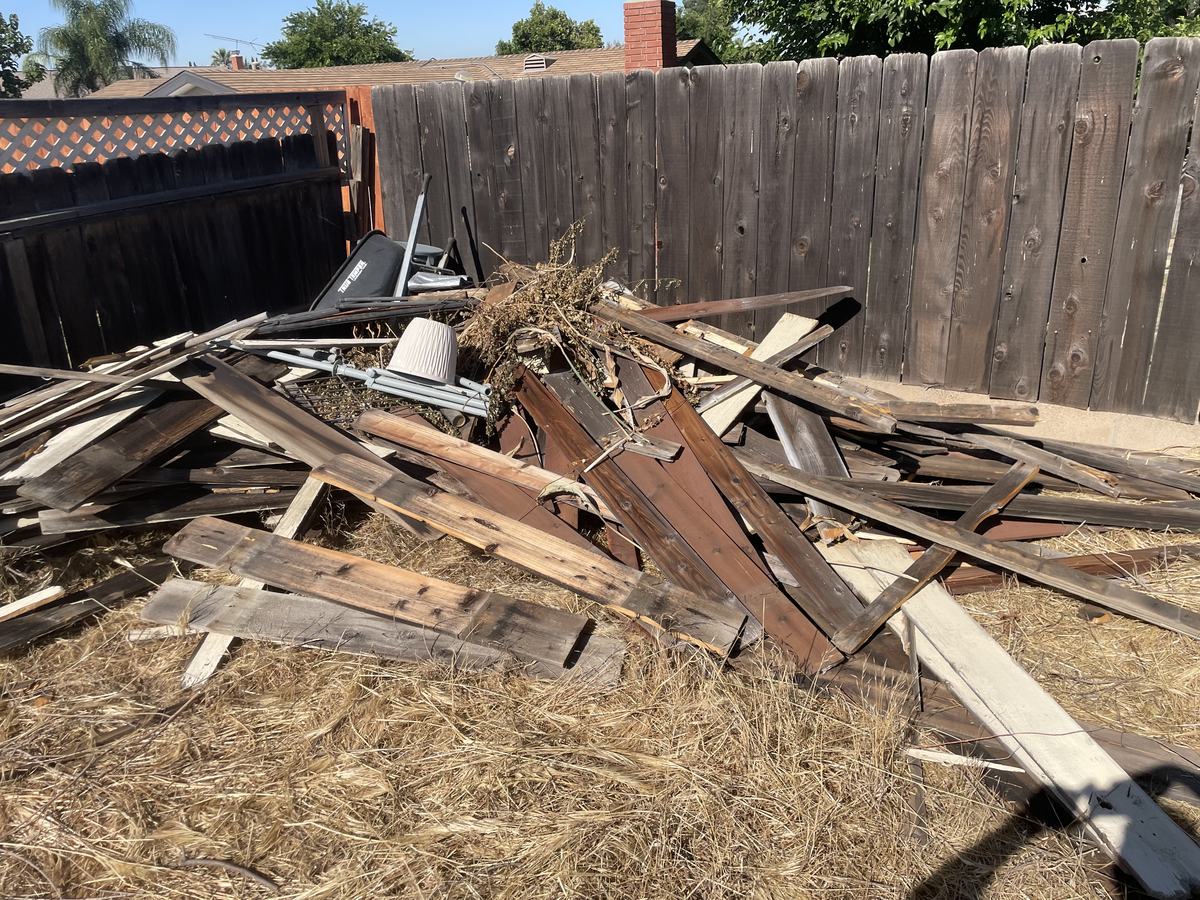 Garage cleanout in Temecula Valley — yard and garage debris pile hauled by Junk Corral