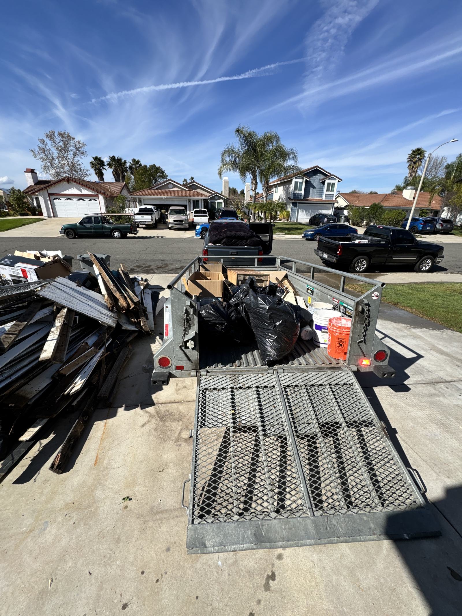 Junk Corral junk removal trailer loading a Temecula Valley job